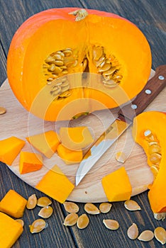 Bright orange cuted pumpkins with pumpkin pieces and seeds