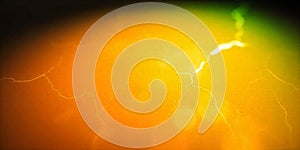 Bright orange and green abstract background with lightning-like patterns illuminating the canvas photo