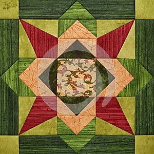 Bright orange-green geometric patchwork block from pieces of fabrics, detail of quilt