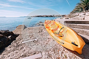 Bright orange kayak is on the sea pier