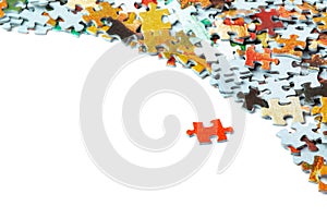 Bright orange puzzle piece and many puzzle pieces