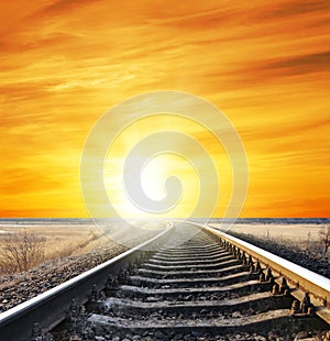 Bright orange sunset over railroad