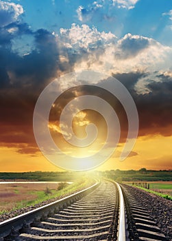 Bright orange sunset over railroad