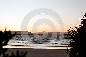 Bright orange sunset sky over Little Wategos Beach in Byron Bay, Australia