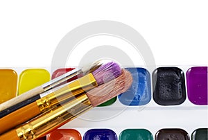 Bright paints watercolors with brushes isolated on white