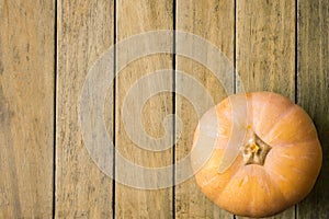 Bright Pale Orange Peachy Heirloom Pumpkin on Plank Wood Background. Copy Space for Text. Thanksgiving Harvest Autumn