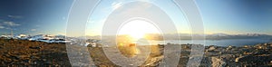 Bright panorama of midnight sun seen from the peak of Nuolja in Northern Sweden