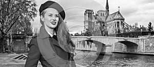 Woman near Notre Dame de Paris looking into the distance