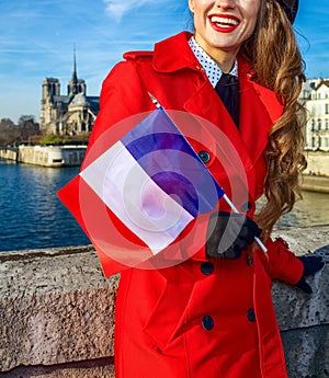 Woman in Paris with French flag looking into the distanc