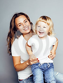 bright picture of hugging mother and daughter happy together, smiling stylish family. girls aloud