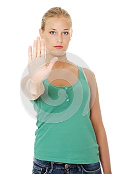 Bright picture of young woman making stop gesture.