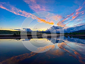 Bright pink blue sunset sky over a reflective pond in Eidsvoll, Norway