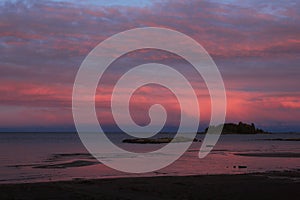 Bright pink clouds over Lake Vanern, Sweden. Sunrise view from Vita Sannar, Mellerud community