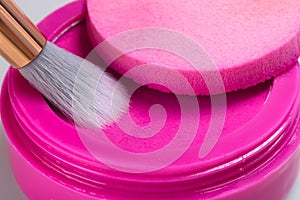 Bright pink eye shadow for applying makeup on the eyelids with a brush, closeup