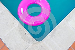 Close up view, bright pink float in blue swimming pool