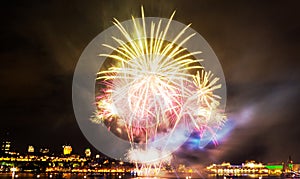 Bright pink and green fireworks in front of Quebec City