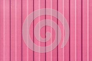 A bright pink painted sheet of corrugated metal. Abstract background for sites and layouts