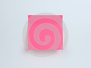 Bright pink sticky note on a plain background