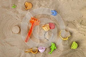 Bright plastic children`s toy in the sand. Children`s toys for t