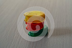 Bright plastic sharpeners on the wooden table, in a pile