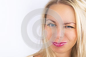Bright positive fashion studio portrait of pretty young blond woman, blue eyes, bright make up, style. Funny Laughing girl