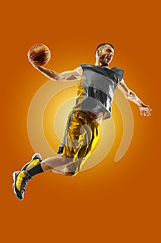 Bright professional basketball player on an orange background