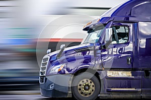 Bright Purple Bonnet Semi Truck Tractor with Reflection Driving on the Road for Delivery Commercial Cargo