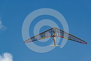 Bright rainbow colored hang glider wing in flight