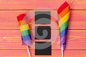 Bright rainbow gay flag on wooden background and blank space