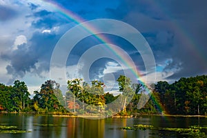 Bright Rainbow Over An Island And Lake In A Storm