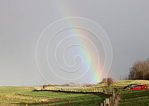 Bright rainbow over sea wall in Pilling Lancashire