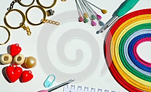 Bright rainbow palette of multi-colored, cotton threads, hooks and accessories isolated on a white background