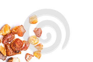 Bright raw Baltic amber on white background.