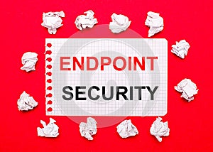 On a bright red background, white crumpled sheets of paper and a sheet of paper with the text ENDPOINT SECURITY