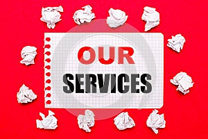 On a bright red background, white crumpled sheets of paper and a sheet of paper with the text OUR SERVICES