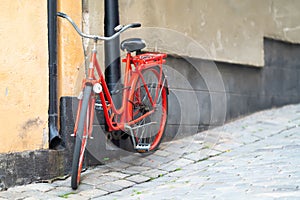 Bright red bicycle parked in an urban street