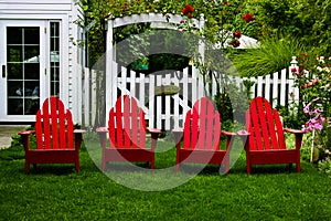 Bright red chairs in a beautiful garden