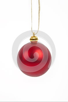 Bright red Christmas tree ball with curly ribbon