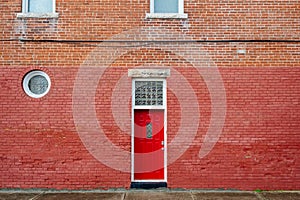 Red door on red brick building