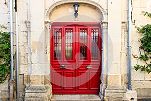 Bright red doors to a medieval house. Rue Hoche, Chinon, France