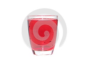 Bright red drinking juic in clear glass isolated on white background