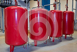 Bright red expansion vessels arranged in a row