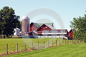 Bright Red Farmhouse and Silo in the Midwest