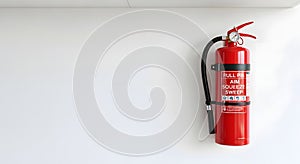 Red Fire Extinguisher Mounted on White Wall