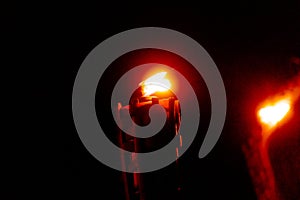 Bright red flame of a torch in a black night