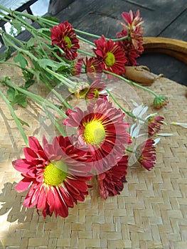 Bright red flowers on bamboo weaven basket