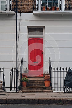 Bright red front door on a house in Primrose Hill, London, UK