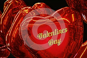Bright red heart shaped mylar balloons Background says Valentines Day - Closeup on black background