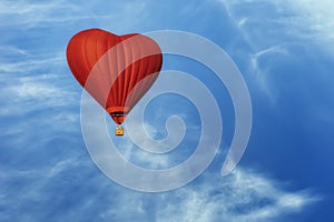 Bright red hot air balloon in the shape of heart