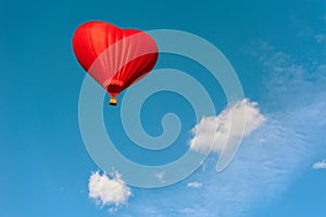 Bright red hot air balloon in the shape of heart